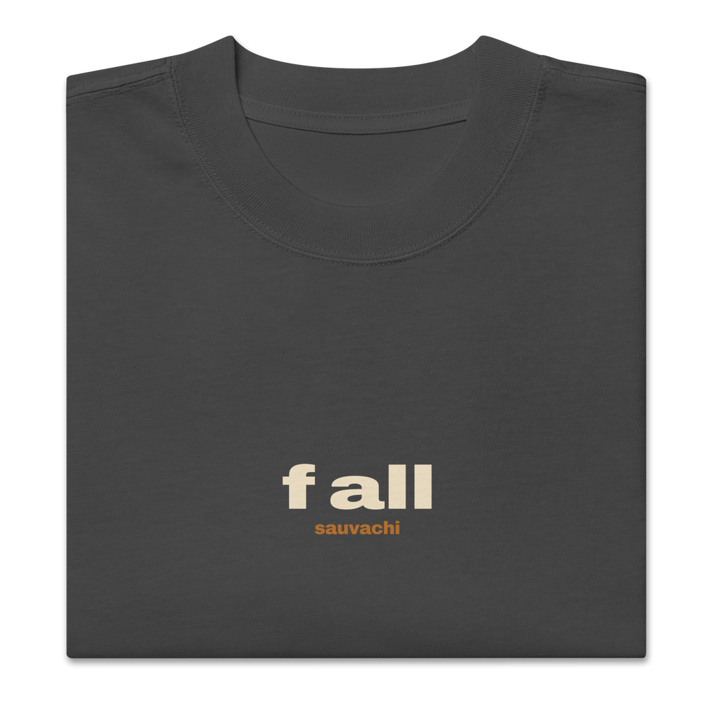 close-up of the faded black tee, folded, showing the small f all and sauvachi chest print and the collar